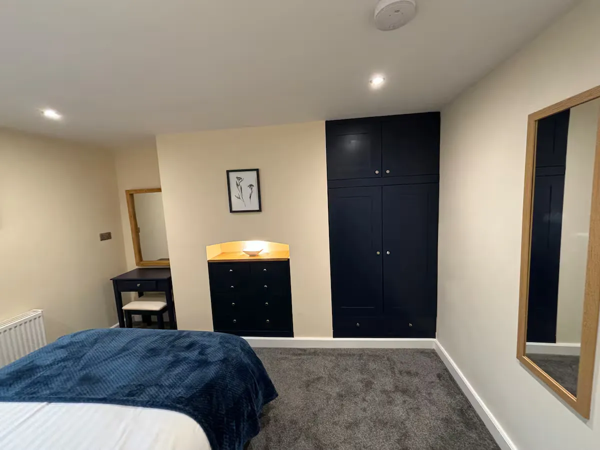 The double bedroom, with smart navy fitted wardrobes