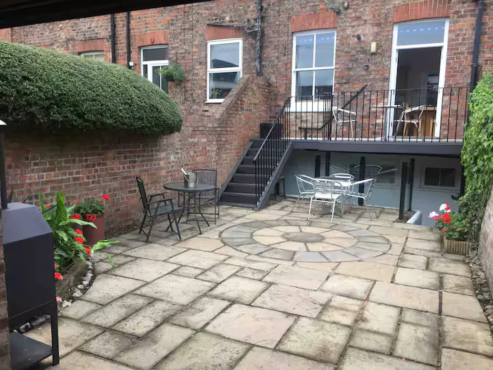 The private flagstone courtyard garden, with café seating and a barbecue